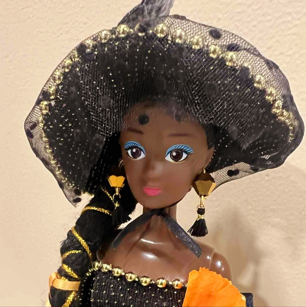 Elegant Black and Gold Doll with Orange Accents